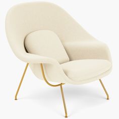 an egg chair with gold legs and a white fabric upholstered seat, viewed from the front