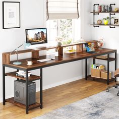 a desk with a computer on it in front of a window