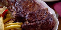 a steak and french fries on a plate