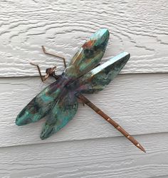 Dragonfly copper garden art sculpture by artist Catherine Murphy of Haw Creek Forge Size:Small 5.5" Wingspan(36" display rod)Large 10" Wingspan, 12" Long(36" display rod)Wall Hang 10" Wingspan, 12" Long(no display rod-cheaper shipping) Artist Catherine Murphy of Haw Creek Forge is a small business with a big reputation for quality, originality and service. In our riverside studio in the mountains of North Carolina, a small group of talented artisans carefully craft each piece of our unique and whimsical garden art, continuing the tradition of handcrafted in America. We take great pride in each piece marked with our HCF studio mark. With brilliant UV resistant paints, patina and torch finishes, each piece is clear coated for weather fastness and durability. Copper Garden Art, Big Reputation, Copper Garden, Dragon Flys, Copper Sculpture, Whimsical Garden Art, Copper Rod, Hang 10, Glass Garden Art