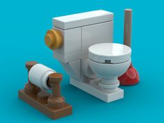 a white toilet sitting next to a wooden plunger on top of a blue surface