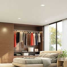 a bedroom with a bed, closet and clothes on hangers in the wall next to it