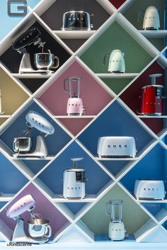 colorful kitchen appliances are displayed on shelves