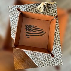 a leather tray with an american flag painted on it