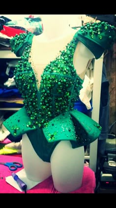 a green leotard with sequins on it