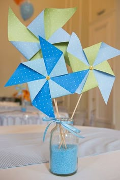 two pinwheels in a mason jar on a table