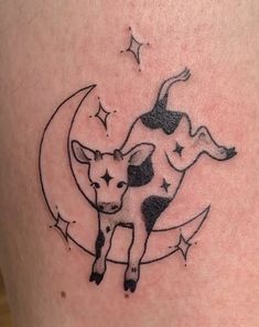 a small cow sitting on the moon with stars around it's neck and back