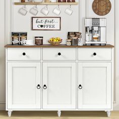 a coffee bar with white cabinets and shelves filled with cups, mugs and other items