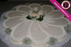 a cake with white frosting and flowers on it