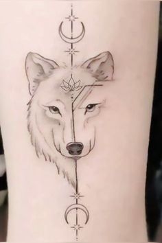 a tattoo with a wolf on it's thigh and an arrow in the middle