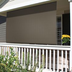 the blinds on the front porch are closed and ready to be used as shade for the sun