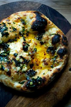 a pizza sitting on top of a wooden cutting board