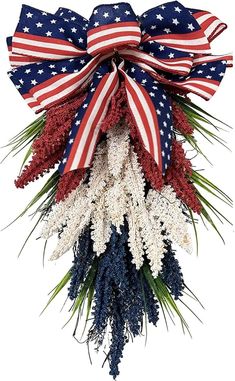 an american flag wreath with red, white and blue flowers on it's side