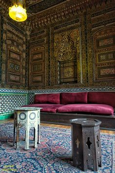 a living room filled with furniture and walls covered in intricately designed wall coverings