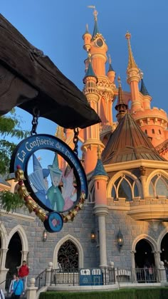 the disneyland castle is lit up at night