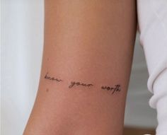 a woman's arm with the words know your worth written on her left side