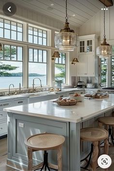 a large kitchen with an island in the middle and lots of stools around it