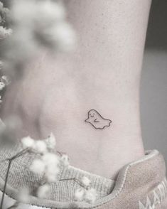 a small bird tattoo on the ankle