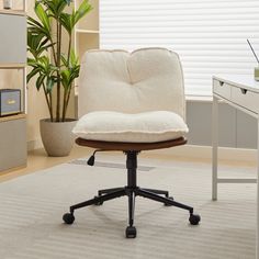 an office chair with a pillow on top of it in front of a computer desk