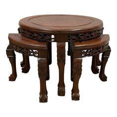 three wooden tables with carved designs on them