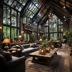 a large living room filled with furniture and lots of tall windows covered in glass walls