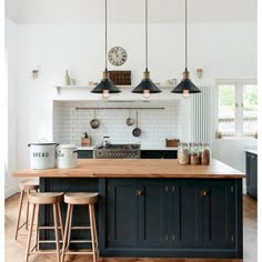 a kitchen with blue cabinets and wooden counter tops