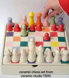 a hand is playing a game of chess