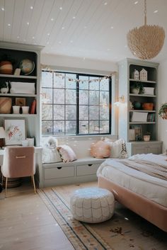 a bedroom with a large bed and lots of shelves on the wall next to it