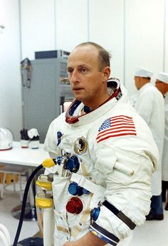 a man in an astronaut suit holding a hose