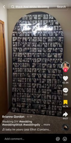 a room with a large display of photos on the wall and texting below it