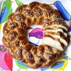 a white plate topped with a bundt cake on top of a colorful table cloth