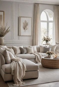 a living room filled with lots of white furniture