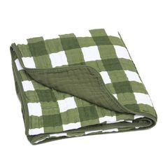 the green and white checkered blanket is folded on top of it's side