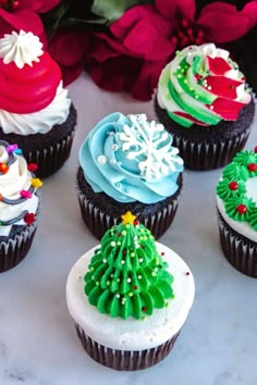 cupcakes decorated with frosting and christmas decorations