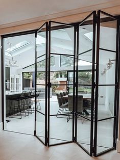 an open room with glass doors and chairs