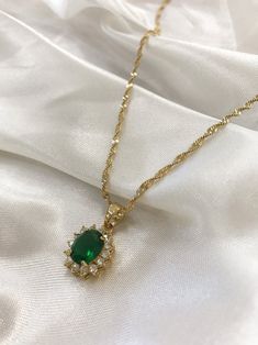 "PRODUCT DETAILS: - CZ encrusted crystal water-drop pendant in emerald green - 24k gold plated rope chain - 18\" chain - 2.5 cm pendant" Elegant Gold Necklace Classy, Dazzling Green Emerald Necklace, Dazzling Gold Emerald Necklace, Dazzling Green Necklaces With Sparkling Stones, Dazzling Gold Emerald Necklace As Gift, Dazzling Gold Emerald Necklace Gift, Dazzling Gold Emerald Necklace For Anniversary, Green Sparkling Stones Necklace For Gift, Dazzling Gold Emerald Necklace For Formal Occasions