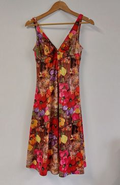 "Fabulous floral print mid-length sleeveless summer dress, circa late 1960s/early 1970s. Fitted style to bust with strappy V-neckline, and full skirt.  The perfect dress for a summer celebration or evening out!  Material: Polyester Condition: Excellent vintage condition - no damage or obvious signs of wear Recommended care: Machine wash Sizing: Label states UK Size 14 - would recommend current UK Size 10/12. Please see exact measurements below. Measurements (item laid flat): - Length (straps to hem) 106cms/41.75\" - Bust (width, doubled) 70cms/27.5\" - Waist (width, doubled) 80cms/31.5\" All items are clean and ready to wear. Want any further details, images or measurements? Feel free to get in touch if you'd like any further information about this item. RETURNS If an item doesn't quite fi Vintage V-neck Sundress, Summer V-neck Vintage Print Dresses, Vintage Summer Floral Dress For Party, Vintage V-neck Sundress For Spring, Vintage Floral Dress For Summer Party, Retro Fitted Floral Print Sundress, Fitted Retro Floral Print Sundress, Fitted Retro Floral Sundress, Summer Party Dress With Vintage Print