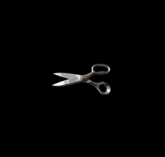 a pair of scissors on a black background