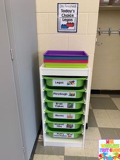 a classroom room with a stack of green and white boxes on the floor next to a locker