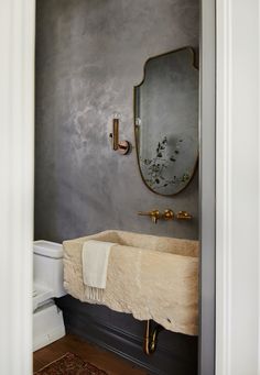 a bathroom with a sink and mirror on the wall