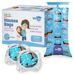 two blue bags with monster faces on them next to a package of baby wipes