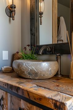 a bowl shaped sink sitting on top of a wooden counter in front of a mirror