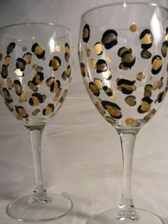 two wine glasses with gold dots on them