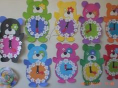 a bunch of colorful teddy bears are hanging on the wall with their faces made out of paper