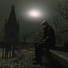 a man sitting on a bench in the dark