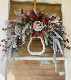 a christmas wreath hanging from the side of a building