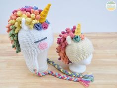 two crocheted unicorn hats on top of a white head and one has a multicolored horn