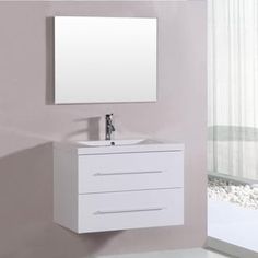 a bathroom vanity with a mirror above it and a white cabinet underneath the sink in front of a window