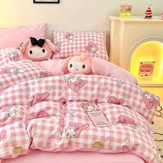 a hello kitty bed set with pink and white checkered sheets