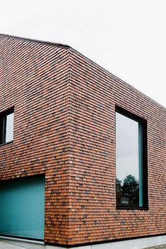 a large brick building with two garages on each side and one door open to let in light